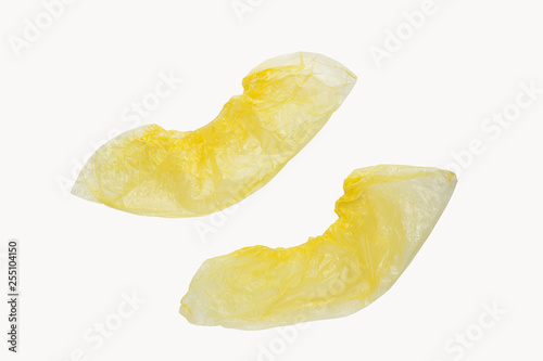 Two medical yellow shoe covers overshoes isolated on white background. Catalog top view photo