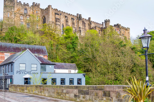 DURHAM, ENGLAND - MAY 1, 2018:Durham Castle and Cathedral on their rock above the city, and Framwellgate Bridge spanning the River Wear, England, UK photo