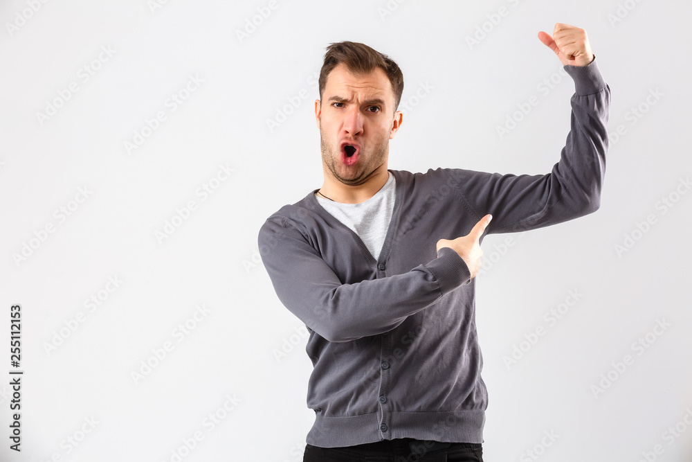 Handsome young business man over wall wearing elegant shirt showing arms muscles smiling proud. Fitness concept. Handsome young business man over wall wearing elegant shirt showing arms muscles smiling proud. Fitness concept.