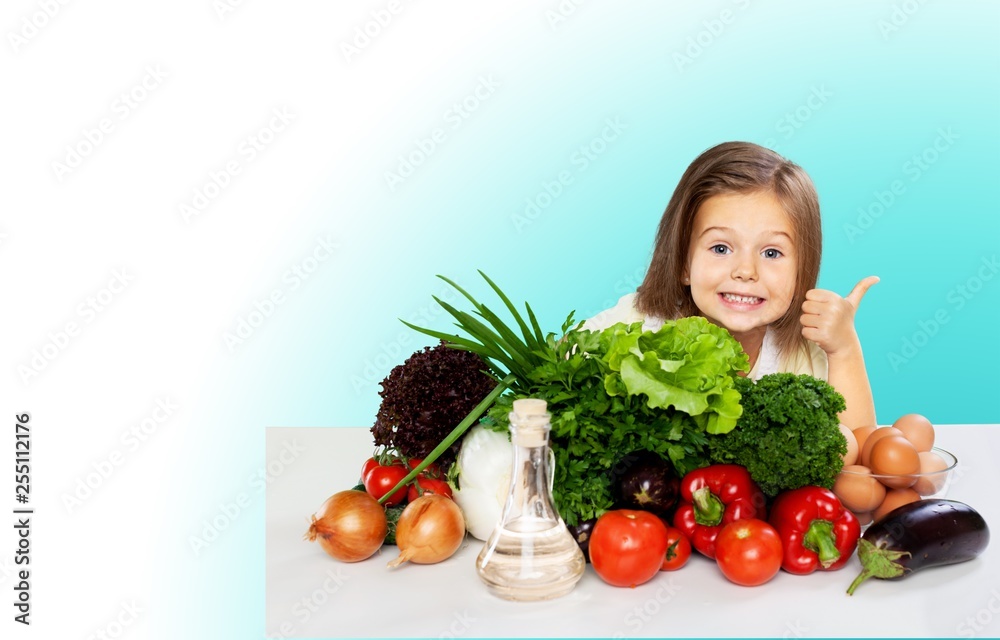 Cute little girl with vegetables in kitchen Cute little girl with vegetables in kitchen