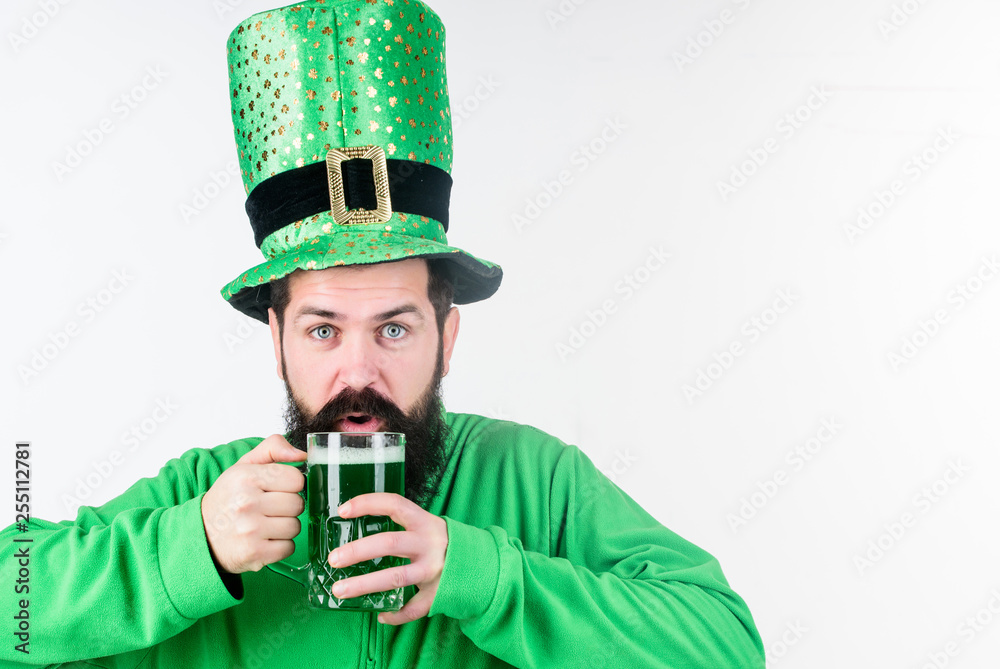 Colored green beer. Green beer part of celebration. Irish pub. Alcohol consumption integral part saint patricks day. Irish culture. Man bearded hipster funny hat drink pint beer. Cheers concept Colored green beer. Green beer part of celebration. Irish pub. Alcohol consumption integral part saint patricks day. Irish culture. Man bearded hipster funny hat drink pint beer. Cheers concept