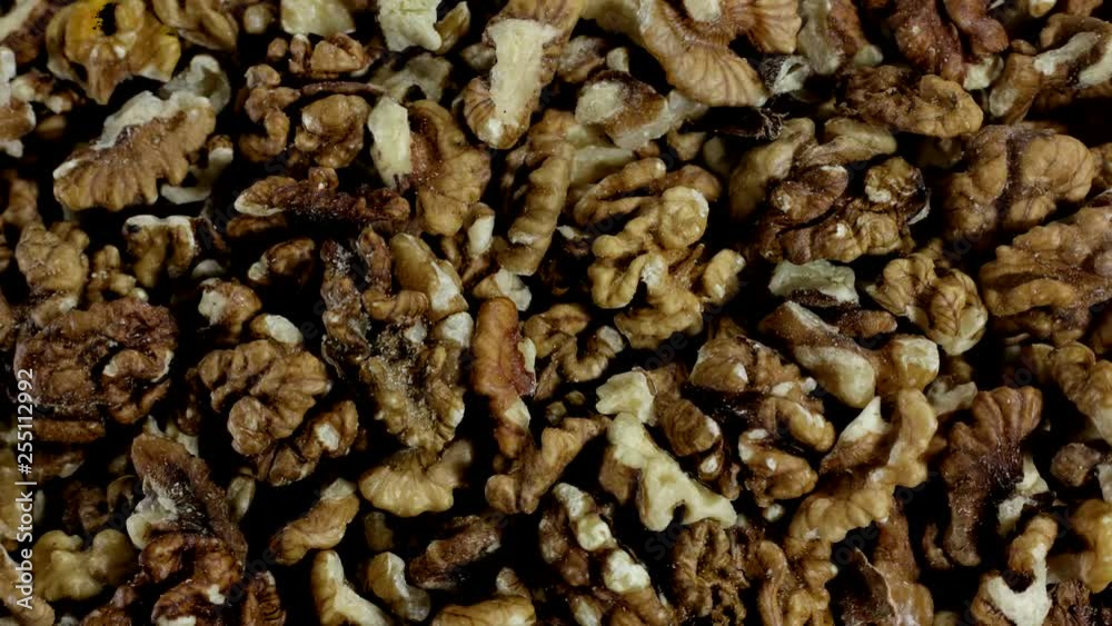 Pile of shelled wallnuts in stop motion. Top view. Background