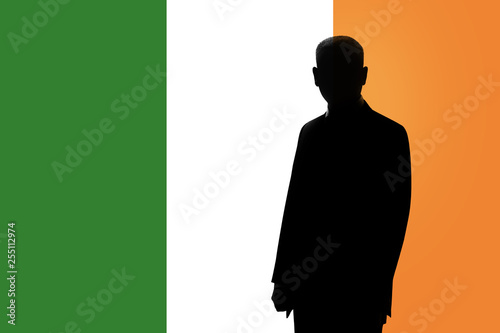 Silhouette of businessman on the background of the Irish flag. Silhouette of a man, with space for text.