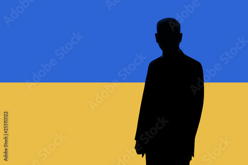 Silhouette of businessman on the background of the Ukrainian flag. Silhouette of a man, with space for text.