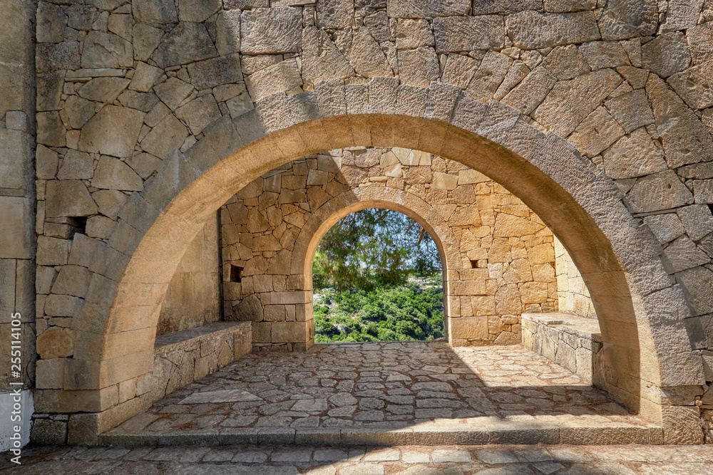Stone arches in monastery garden, Arkadi monastery in Crete