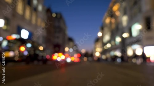 Dusk city traffic. Abstract, defocussed, low and wide angle video footage of the bright shop fronts of Oxford Street, London, at dusk.