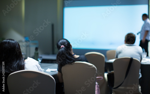"Audience and Lecturer at a Conference Meeting Seminar Training. Group of People Hear Presenter Give Speech. Corporate Manager Speaker Gives Business Team Presentation. Education Presenter Event Photo