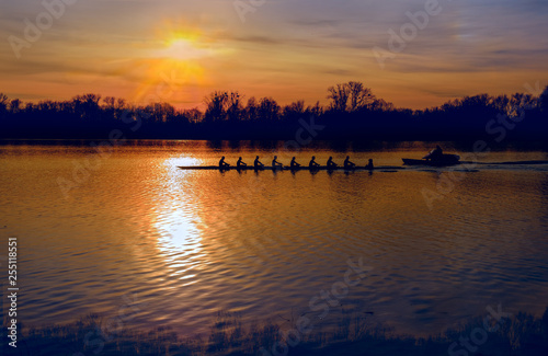 Silhouette of row boat against sunset on the lake