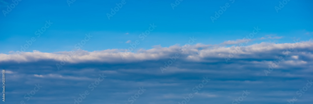 white clouds against the blue sky on a sunny day.