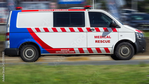 red white and blue medical rescue vehicle with motion blur