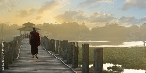 monk walking on U bein bridge at Mandalay,Myanmar