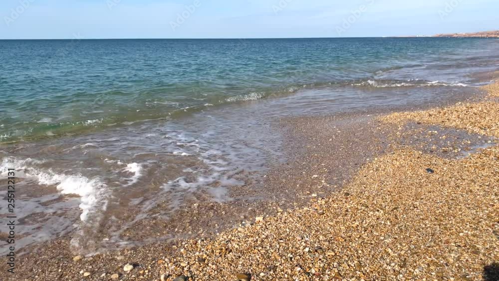 Calm sea with clear water. The waves roll on shore. Calm sea with clear water. The waves roll on shore.
