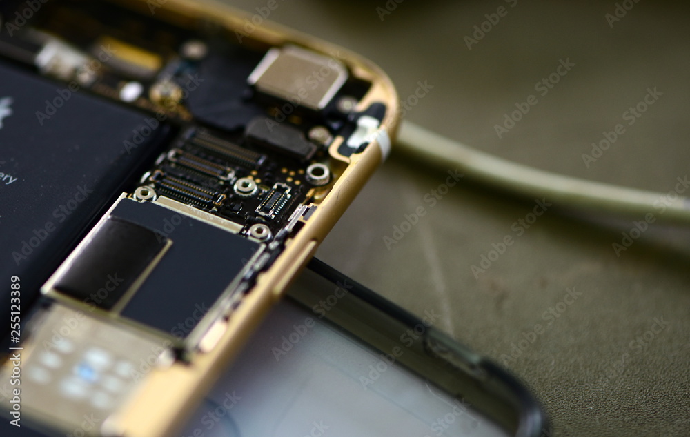 technician repairing broken mobile phone close-up.Close-up Of A Human Hand Repairing Smartphone With Screwdriver Internal circuits and structural elements of mobile phones,Tools and equipment .