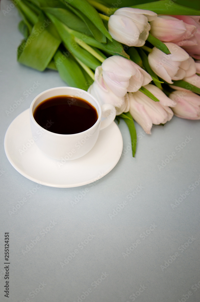 Obraz premium flowers tulips with white coffee Cup on blue background