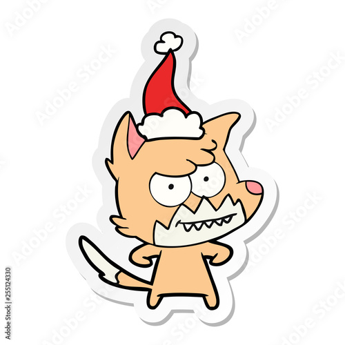 sticker cartoon of a grinning fox wearing santa hat © lineartestpilot