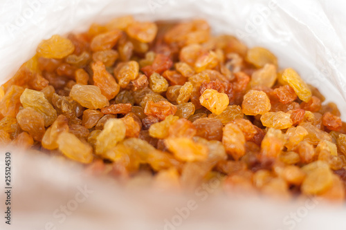 Delicious yellow raisins, highest grade. Delicious and beautiful background or wallpaper, selective focus, top view