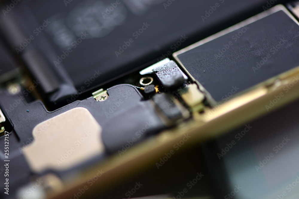 technician repairing broken mobile phone close-up.Close-up Of A Human Hand Repairing Smartphone With Screwdriver Internal circuits and structural elements of mobile phones technician repairing broken mobile phone close-up.Close-up Of A Human Hand Repairing Smartphone With Screwdriver Internal circuits and structural elements of mobile phones