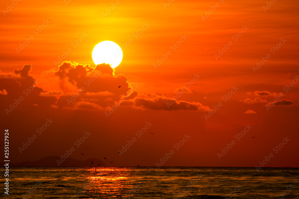 multicolor heap red sunset cloud and sun on sky over sea