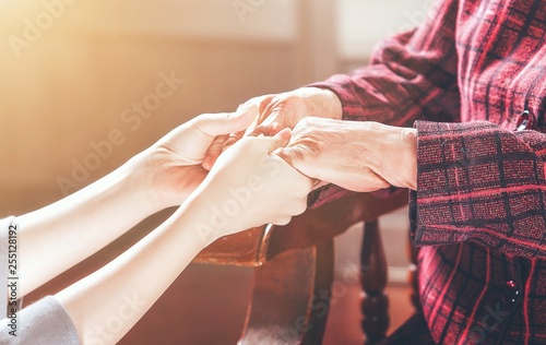 Vászonkép Teenage asia young girl carer holding grandma hands, concept of helping care for