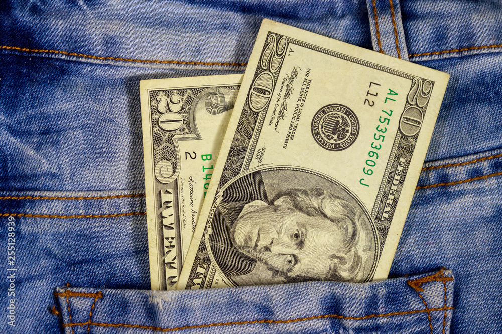 Twenty dollars bill in the pocket of blue jeans Twenty dollars bill in the pocket of blue jeans
