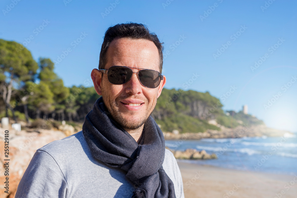 Outdoors lifestyle fashion close up portrait of pretty handsome guy, smiling and having fun. Wearing stylish sunglasses Outdoors lifestyle fashion close up portrait of pretty handsome guy, smiling and having fun. Wearing stylish sunglasses