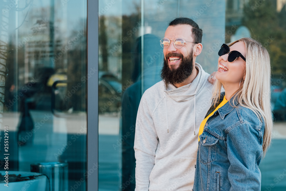 Casual young couple. Urban lifestyle. Smiling young man and woman. Copy space for advertising text. Casual young couple. Urban lifestyle. Smiling young man and woman. Copy space for advertising text.