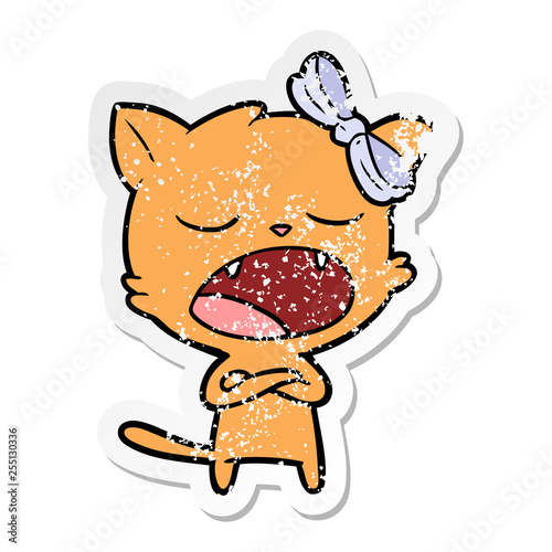 distressed sticker of a cartoon yawning cat