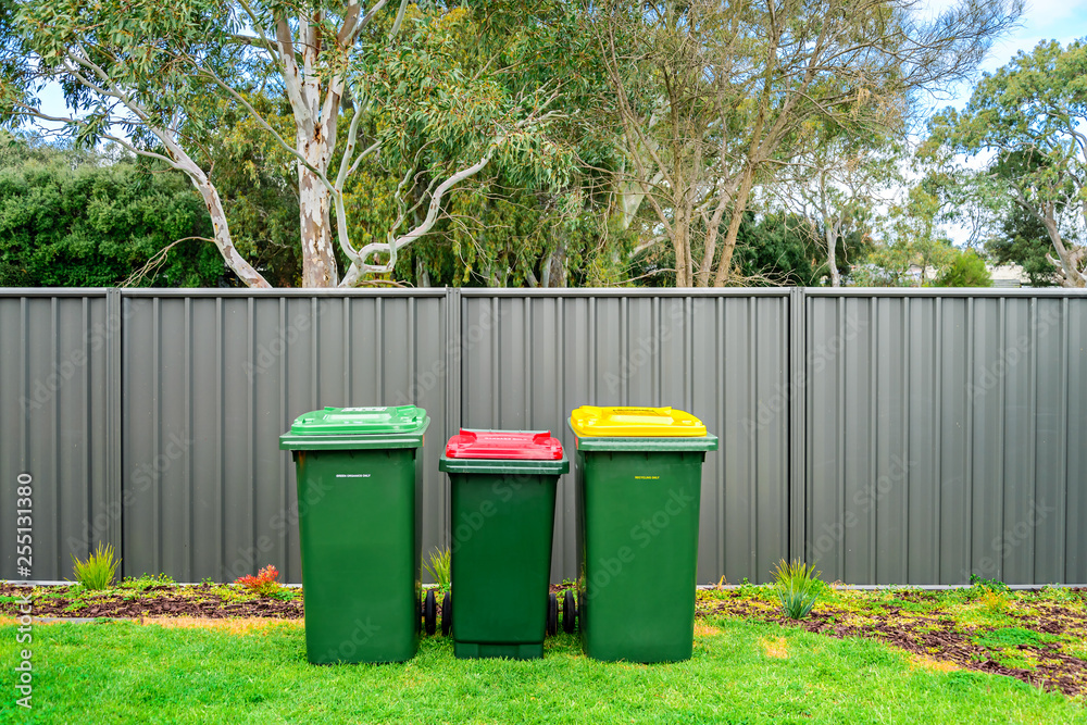 Fotografie Australian home waste bins set on backyard