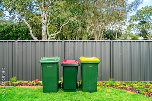 Australian home waste bins set on backyard photo