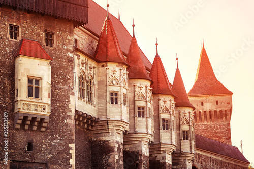 Beautiful view of castle with wooden bridge and high towers photo