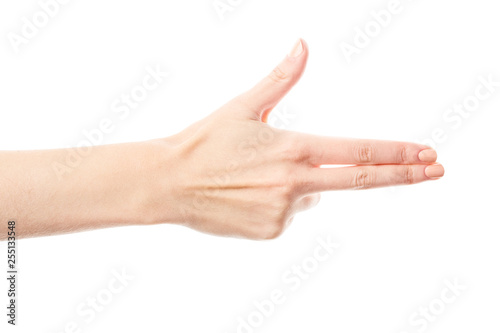 Woman's hand making shooting gun, gesture. hand pistol gesture on isolated white background. Woman hand pointing  with two fingers photo