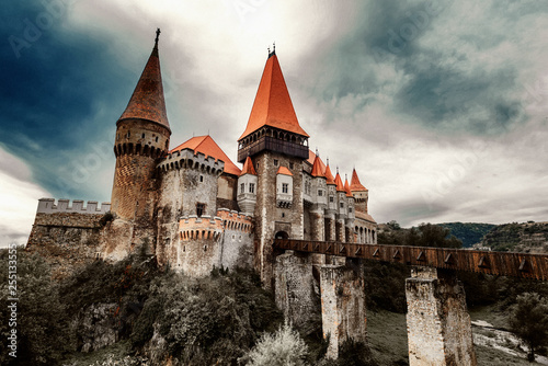 Beautiful view of castle with wooden bridge and high towers photo