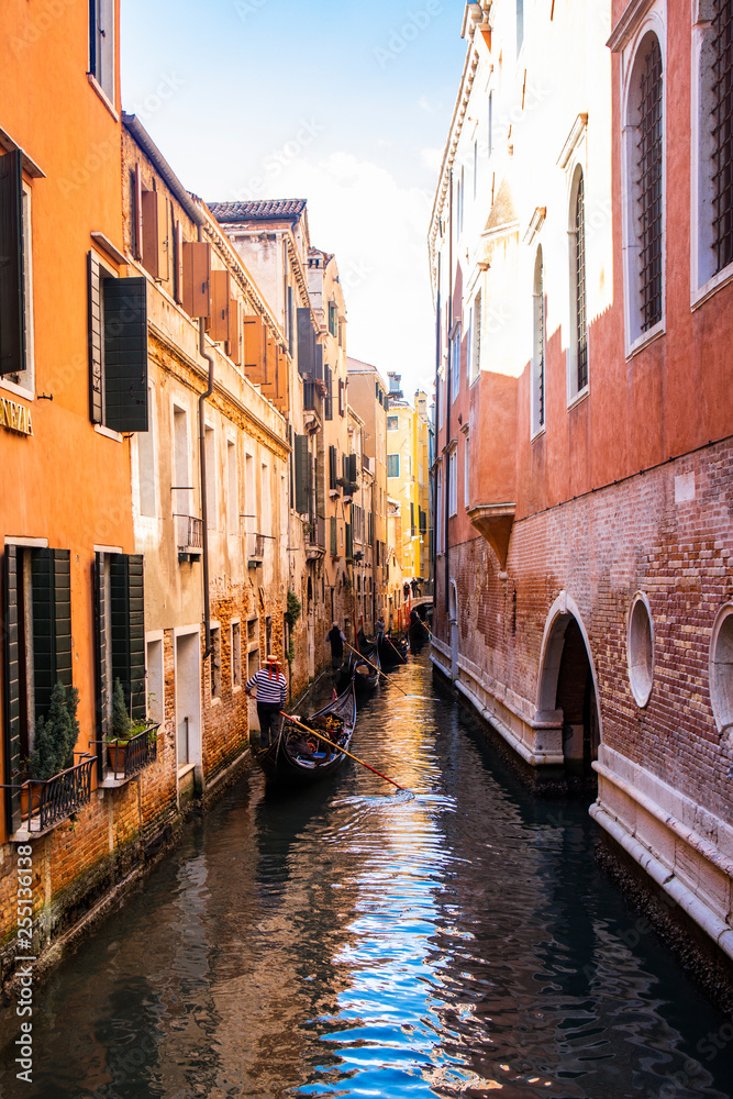 Canal with gondolas in Venice in a sunny day