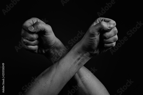 Two fists isolated on black background. Black and white