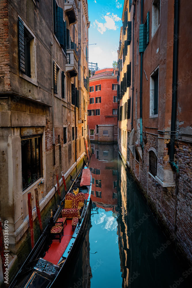 Narrow canal with gondola in Venice, Italy