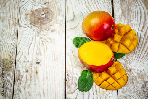 Famous Alphonso mango slices over wood background, Top view