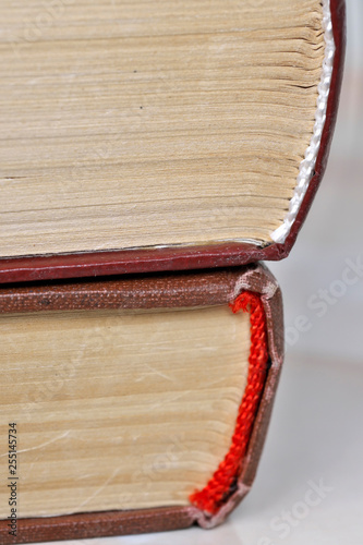 Stack old books in a light cover photo