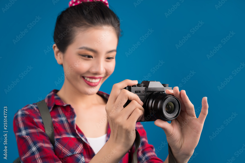 Woman travel. Young beautiful asian woman traveler taking pictures on blue background Woman travel. Young beautiful asian woman traveler taking pictures on blue background