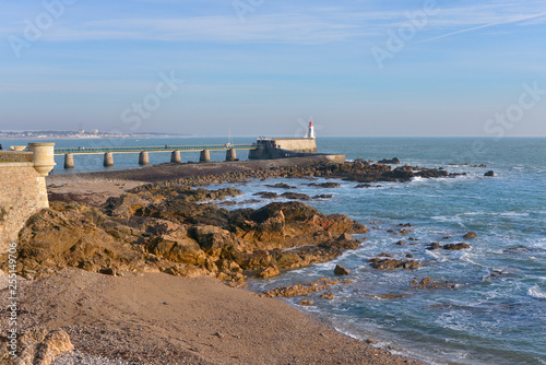 Tableau sur toile Rocky coastline and lighthouse at Les Sables d'Olonne, commune in the Vendée dep