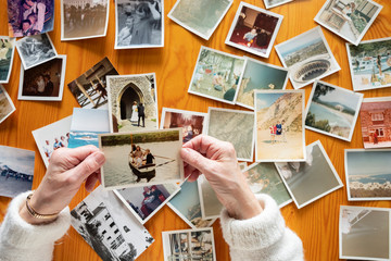 Top view of a senior caucasian woman looking at an old photos themes of memories nostalgia photos retired