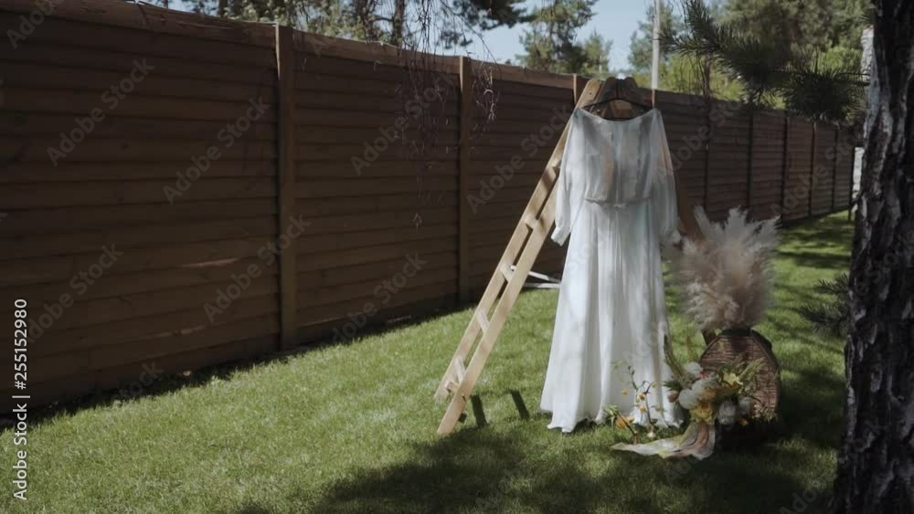 wedding dress and flower wedding decoration in rustic style on the lawn wedding dress and flower wedding decoration in rustic style on the lawn