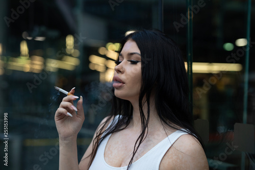 portrait of young woman with bad habits 