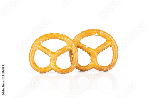 Group of two whole mini salted pretzels isolated on white background