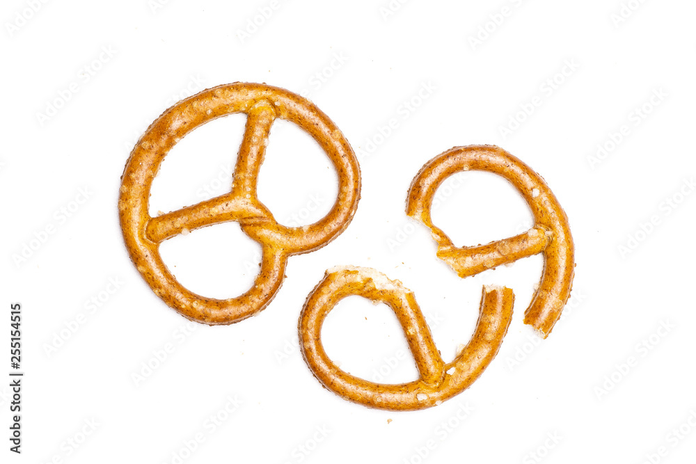 Group of one whole two halves of mini salted pretzels flatlay isolated on white background