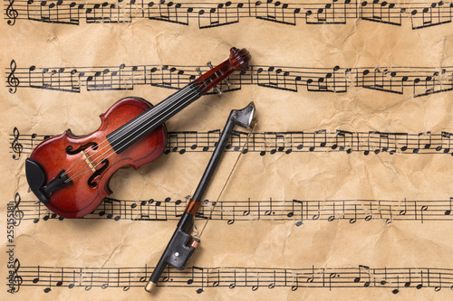 Violin on antique paper music notes with copy space