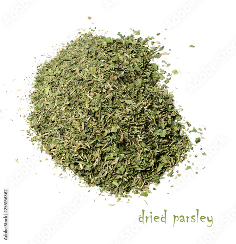 Dried chopped parsley on a white isolated background. View from above.