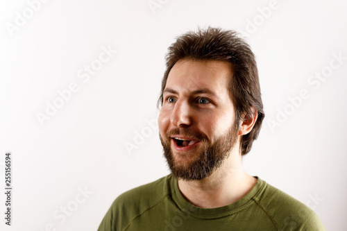 Portrait of young man with positively shocked facial expression.