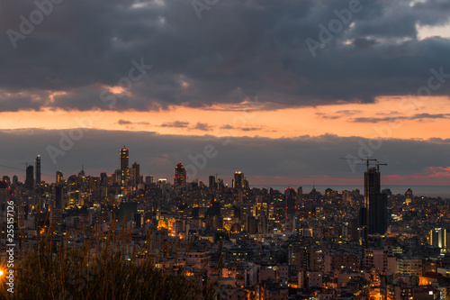 This is a capture of the sunset in Beirut capital of Lebanon with a warm orange color, and you can see Beirut downtown in the foreground with some beautiful cloud in the background