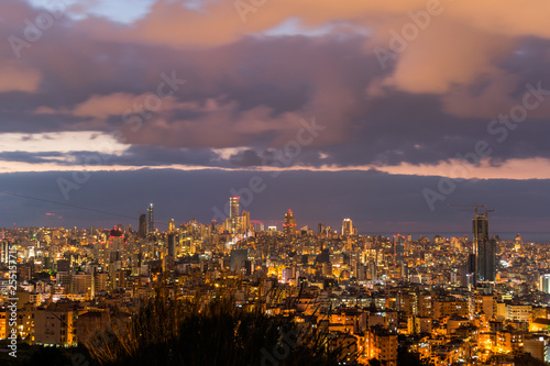 This is a capture of the sunset in Beirut capital of Lebanon with a warm orange color, and you can see Beirut downtown in the foreground with some beautiful cloud in the background © Edds