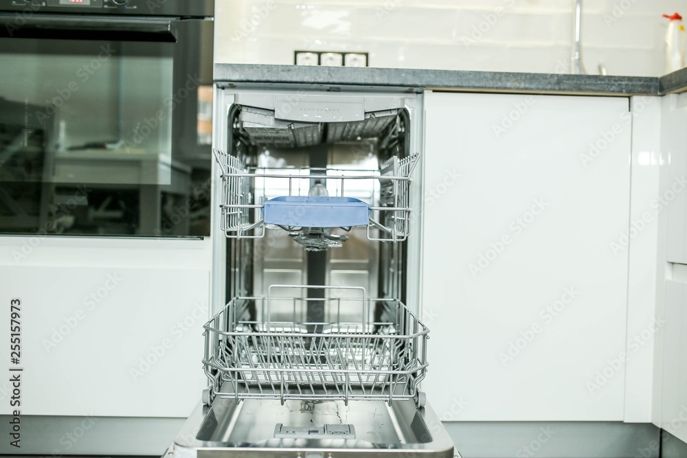 modern electric dishwasher built into the furniture in the kitchen. modern electric dishwasher built into the furniture in the kitchen.